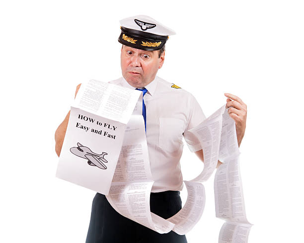 istock The pilot looks into instructions about using the aircraft, isolated on white background. Aircraft captain is studying a manual about flying. 2206226308