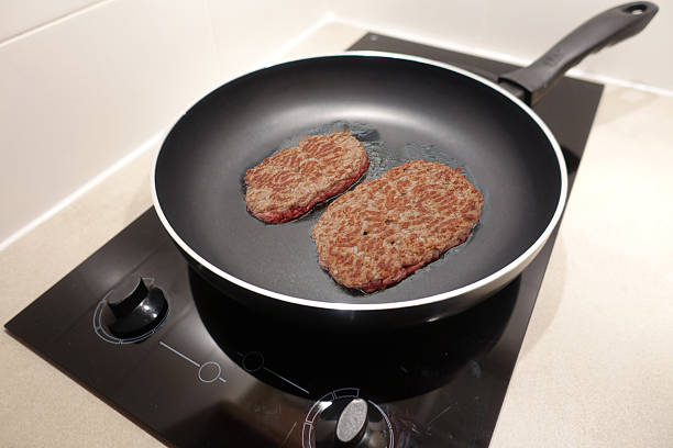 Browned ground beef being cooked in a frying pan