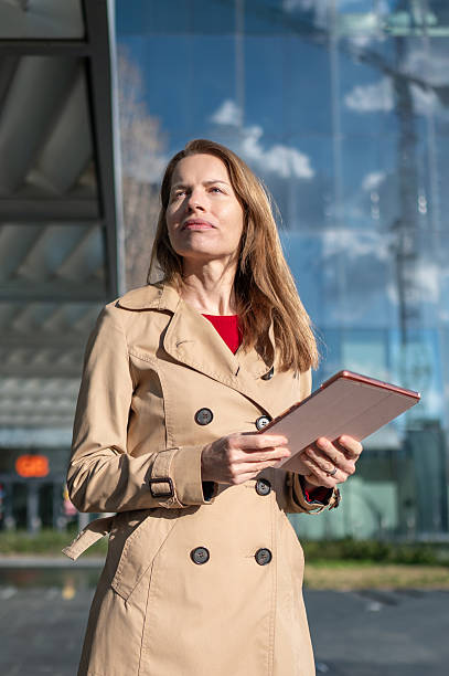 istock Businesswoman holding digital tablet looking up contemplating next move 2206236338