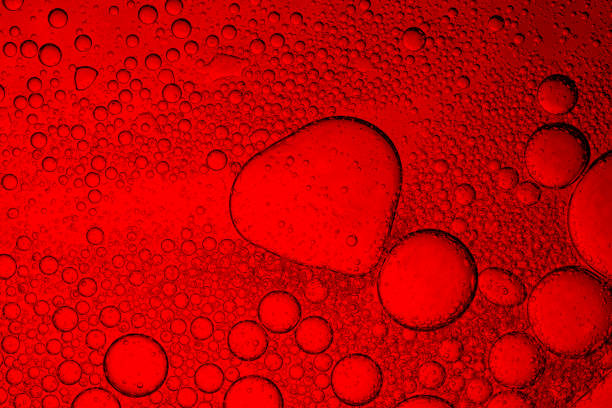 istock Macro drink bubbles,red macro bubbles,Backgrounds, Abstract Backgrounds, Soda, Red, Carbonated,Beauty concept background. Closeup cosmetic liquid gel with bubbles on red colors background 2206239495