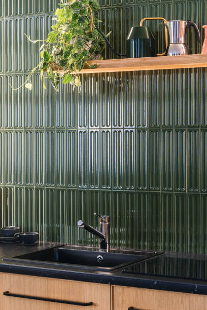istock Modern kitchen design featuring sleek cabinets and stylish green wall tiles 2206241611