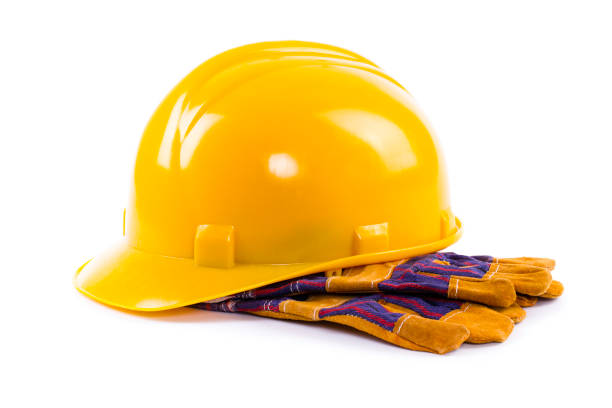 istock Safety gear including yellow hard hat and work gloves ready for construction site activity during the day 2206242997