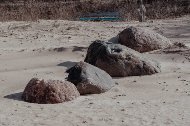 istock Large Natural Boulders on a Sandy Beach with Soft Shadows 2206243794
