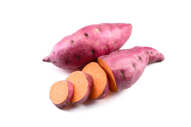 istock Whole and sliced pink sweet potatoes isolated on white 2206244293