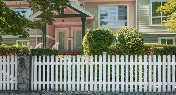 istock charming small town America cottage with picket fence. 2206244913