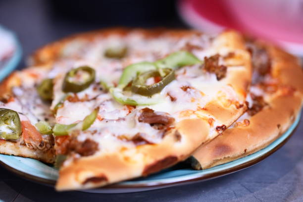 Crusty delicious meat pizza on oak table