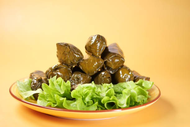 Traditional dolma grape leaves on a plate .