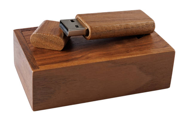 Wooden USB flash drive on a wooden gift box isolated on a white background.