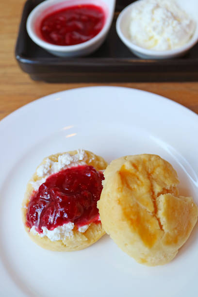 istock Mouthwatering Scone Topped with Whipped Cream and Raspberry Jam 2206247690