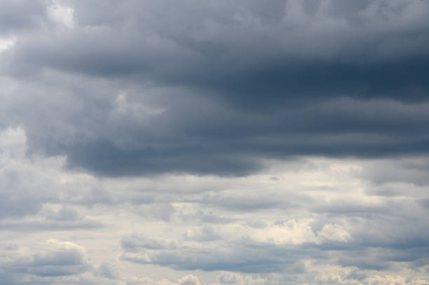 istock Dramatic clouds gather over a tranquil landscape at dusk, hinting at an approaching storm and the promise of rain 2206247878