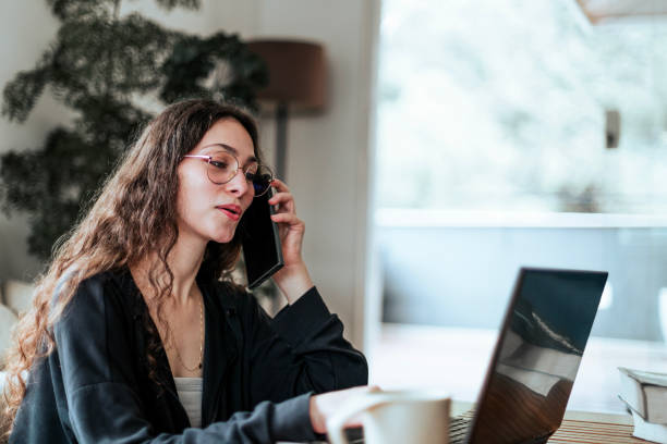 istock Young woman working at home with her dog by her side 2206248358
