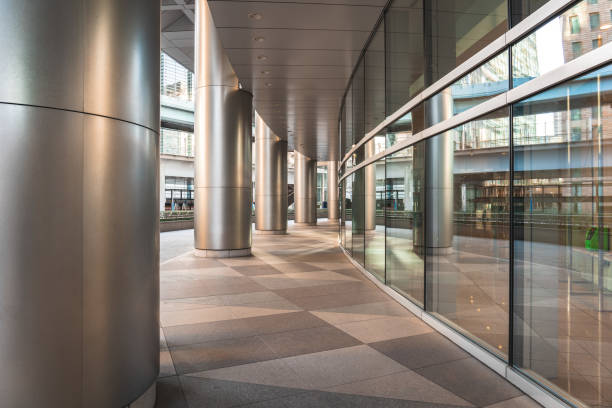 Empty walkway along a modern building with metal pillars and glass facade in tokyo, japan