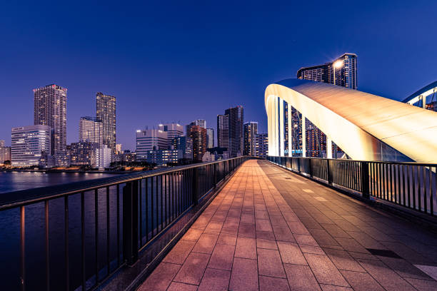 istock Modern bridge with illuminated arch spanning sumida river in tokyo at twilight 2206248414
