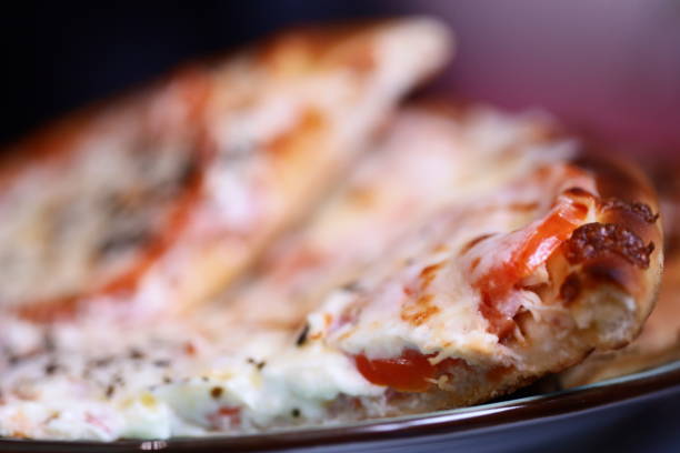 Freshly baked pizza slice served on a plate, ready to be devoured.