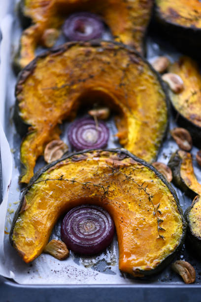 istock Baking pumpkins with onion and spices in the baking oven 2206249847