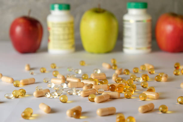 istock Healthy living with vitamins and fresh apples on a bright table 2206250309
