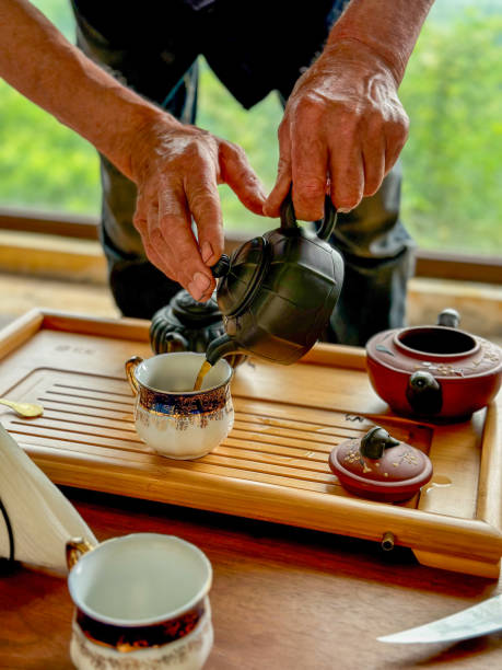 istock Traditional Chinese Tea Ceremony – Pouring Tea into a Porcelain Cup 2206250482