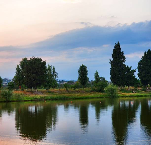 istock Tranquil lakeside reflection - lush trees and natural surroundings, Georgia 2206250623