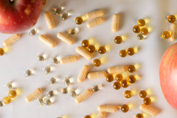 istock Colorful vitamins and fresh apples create a vibrant health message 2206250707