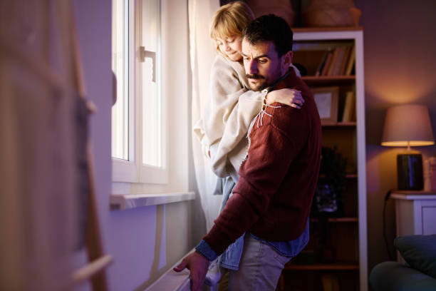 istock Father holding his daughter is checking the heating during an energy crisis 2206251984