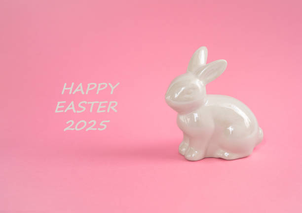 istock Happy Easter 2025 greeting with bunny and eggs on pink background 2206253236