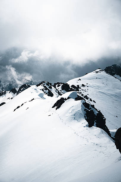 istock Footprints in snow up mountain ridge 2206253475