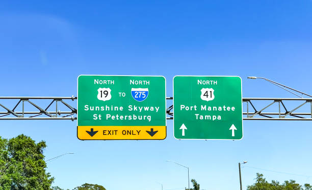 istock Overhead Florida highway directional signs against blue sky 2206253862