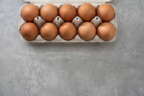 istock Chicken eggs lie in a tray on a light background. Fresh egg on morning breakfast. Concept farm products and natural nutrition 2206253884
