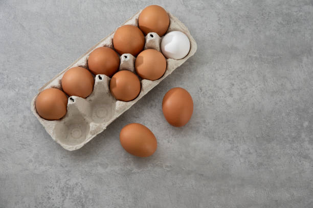 istock Chicken eggs lie in a tray on a light background. Fresh egg on morning breakfast. Concept farm products and natural nutrition 2206253885