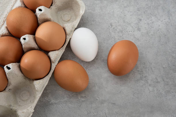 istock Chicken eggs lie in a tray on a light background. Fresh egg on morning breakfast. Concept farm products and natural nutrition 2206253887