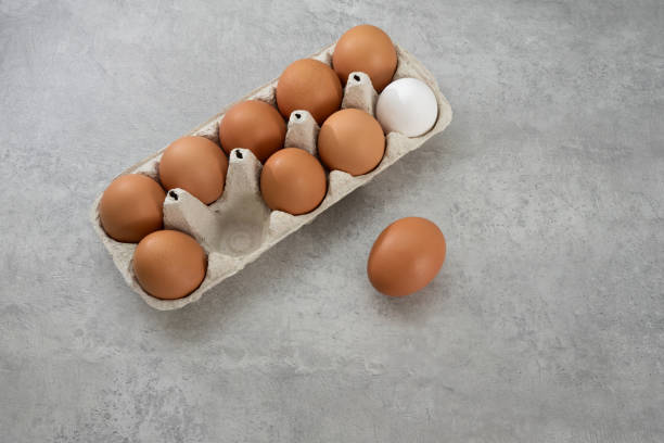 istock Chicken eggs lie in a tray on a light background. Fresh egg on morning breakfast. Concept farm products and natural nutrition 2206253888