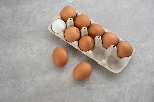 istock Chicken eggs lie in a tray on a light background. Fresh egg on morning breakfast. Concept farm products and natural nutrition 2206253890