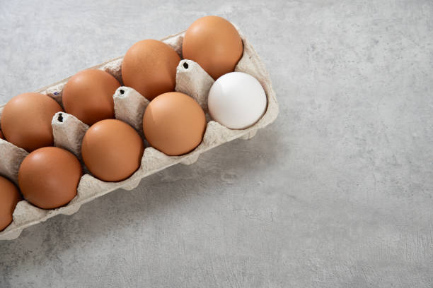 istock Chicken eggs lie in a tray on a light background. Fresh egg on morning breakfast. Concept farm products and natural nutrition 2206253892