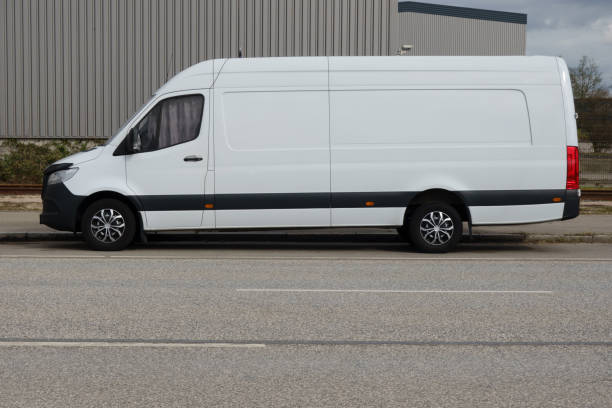 istock White delivery van parked in an industrial area 2206254153
