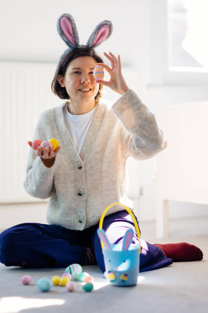 istock Happy young woman is holding Easter eggs 2206254256