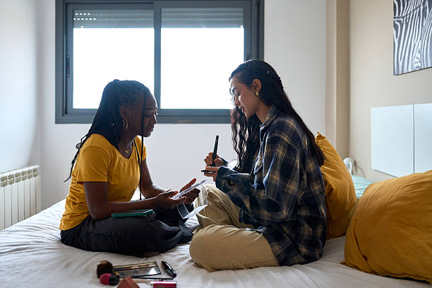 istock Two young women doing makeup together in bedroom 2206255275
