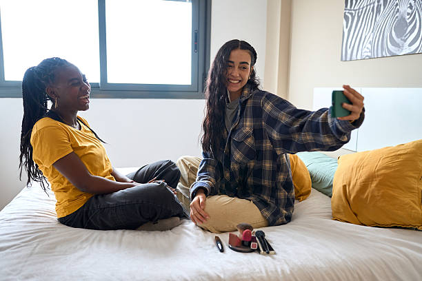 istock Two young women taking selfies on bed in bedroom 2206255895