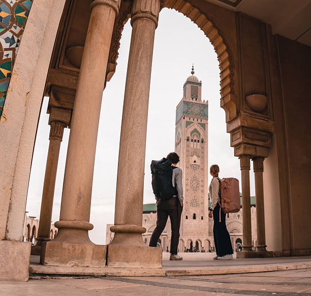 istock Young couple explore inner courtyard of mosque 2206255920