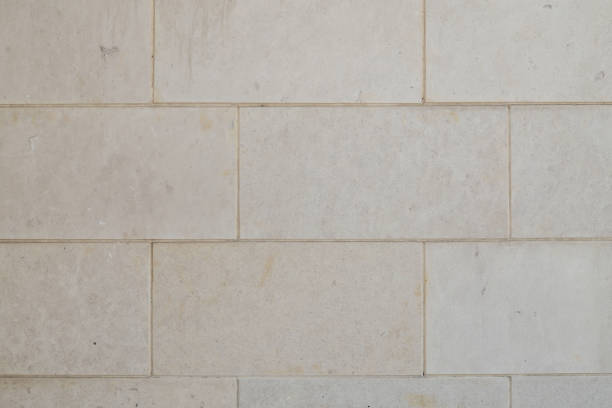 Close-up of a wall made of rectangular stone bricks in a neutral color