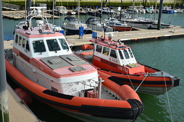 Blankenberge, West-Flanders, Belgium - February 23 2025:  2 lifeguard service motorboats  lie in the marina at the floating jetties