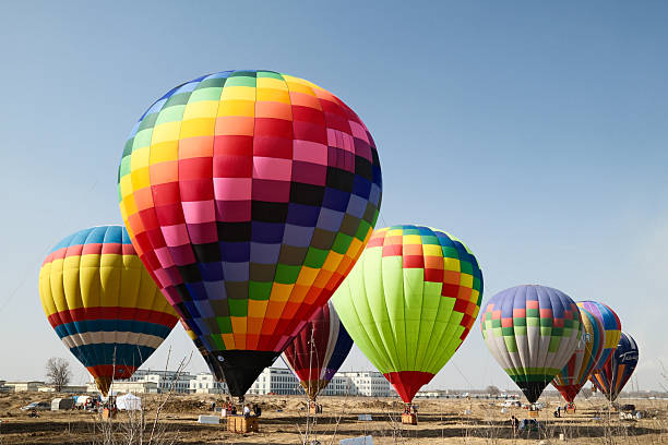 Colorful hot air balloons taking flight on a sunny day