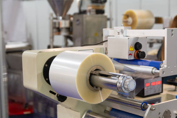 istock A roll of plastic film above a packaging conveyor for food packaging or plastic packaging bag production 2206258933