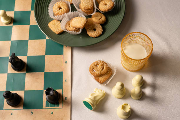 istock Enjoying chess and cookies with milk on a table 2206261107
