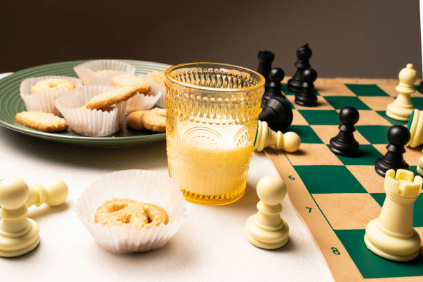 istock Cookies and milk chess night on white tablecloth 2206261215