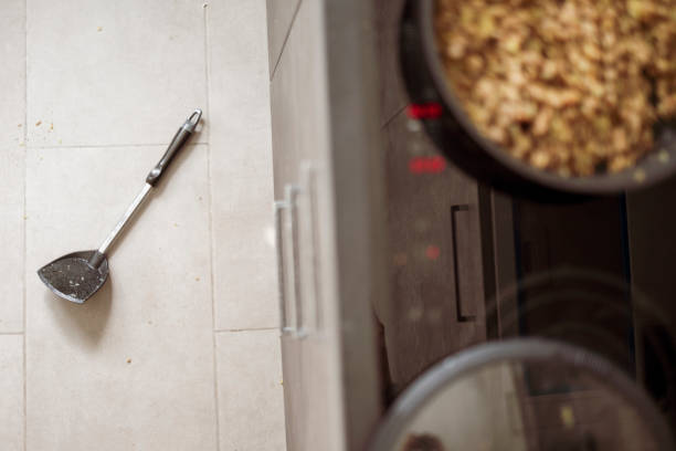 Blurred kitchen background and white cupboard with wooden shutter doors. Stylish cabinet with louver slats. Cozy home scene and atmosphere hygge. Warm light.