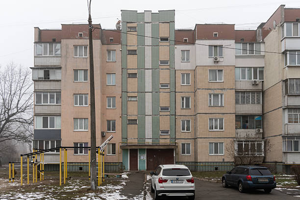 The weathered exterior of an abandoned apartment building