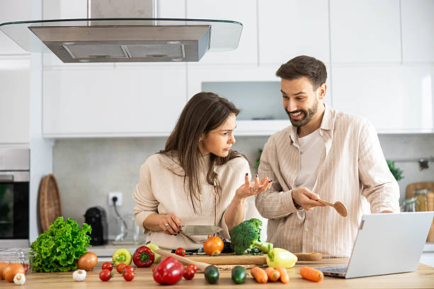 istock Curious Couple Cooking Together with Veggies 2206262050