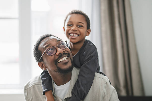 istock Father and son having great time on the livingroom 2206262085