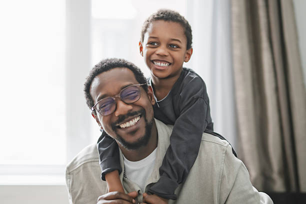istock Father and son having great time on the livingroom 2206262086