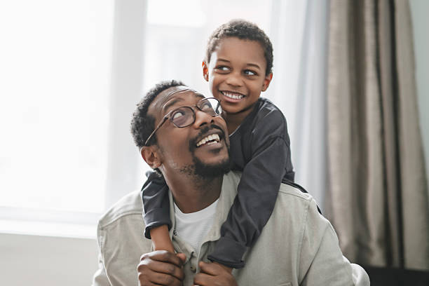 istock Father and son having great time on the livingroom 2206262087